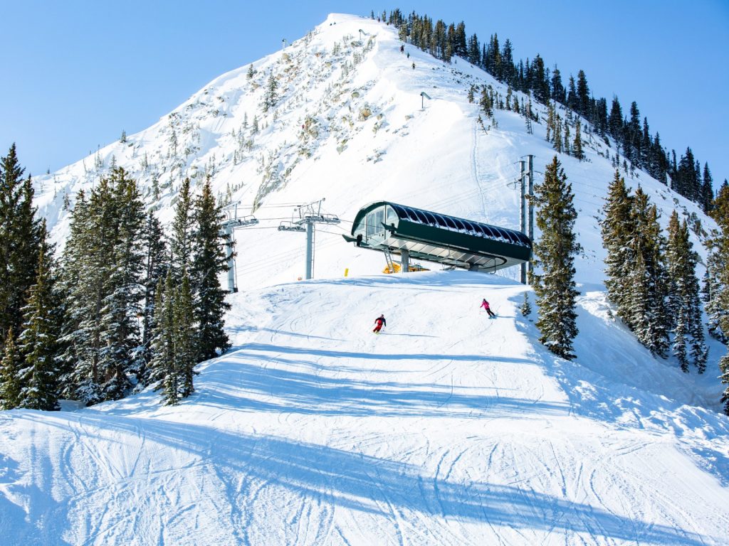 Upward angle view of the Milly Express charlift with Mt. Millicent in the background